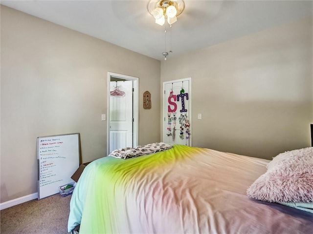 bedroom featuring carpet floors, a ceiling fan, and baseboards