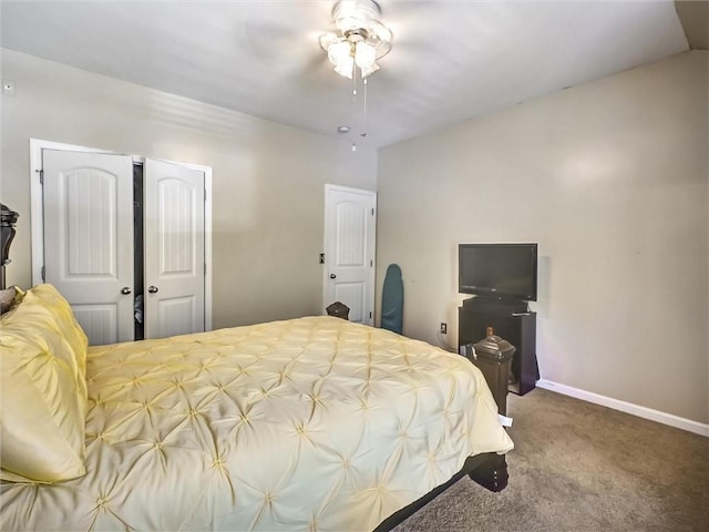 bedroom with baseboards, carpet floors, a closet, and ceiling fan