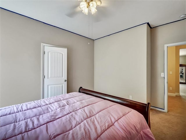 bedroom with baseboards, light colored carpet, and ceiling fan