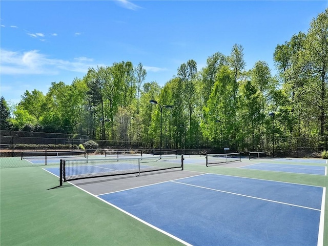 view of tennis court with fence and community basketball court