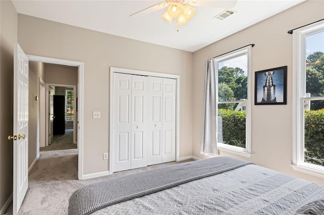 3072 Oaktree Ln, Duluth, GA 30096 - carpeted bedroom featuring multiple windows, a closet, and a ceiling fan