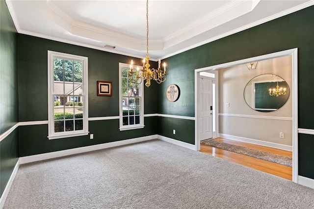 3072 Oaktree Ln, Duluth, GA 30096 - empty room with a chandelier, carpet, ornamental molding, a tray ceiling, and wood finished floors