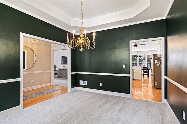3072 Oaktree Ln, Duluth, GA 30096 - spare room featuring a chandelier, wood finished floors, crown molding, carpet floors, and a raised ceiling