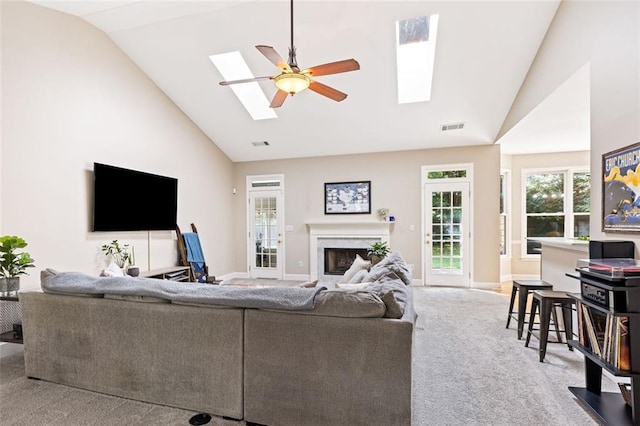 3072 Oaktree Ln, Duluth, GA 30096 - carpeted living room featuring a skylight, ceiling fan, a fireplace, and high vaulted ceiling