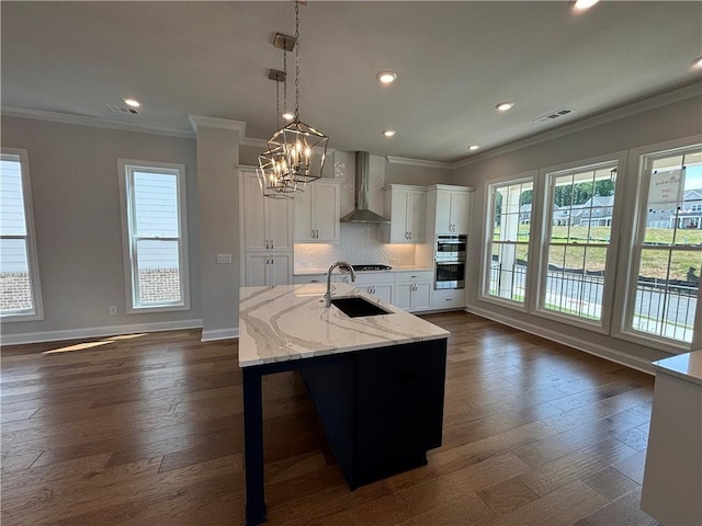 173 Basil St, Cumming, GA 30040 - kitchen featuring a sink, wall chimney range hood, plenty of natural light, double oven, and crown molding