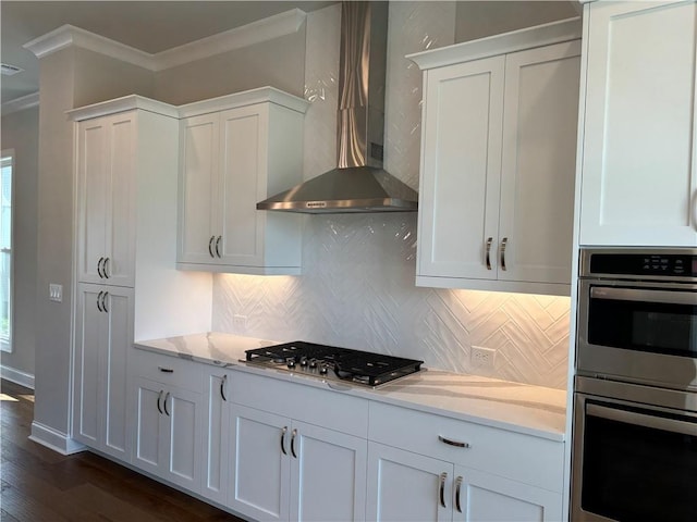 173 Basil St, Cumming, GA 30040 - kitchen featuring stainless steel appliances, wall chimney exhaust hood, ornamental molding, dark wood-type flooring, and tasteful backsplash