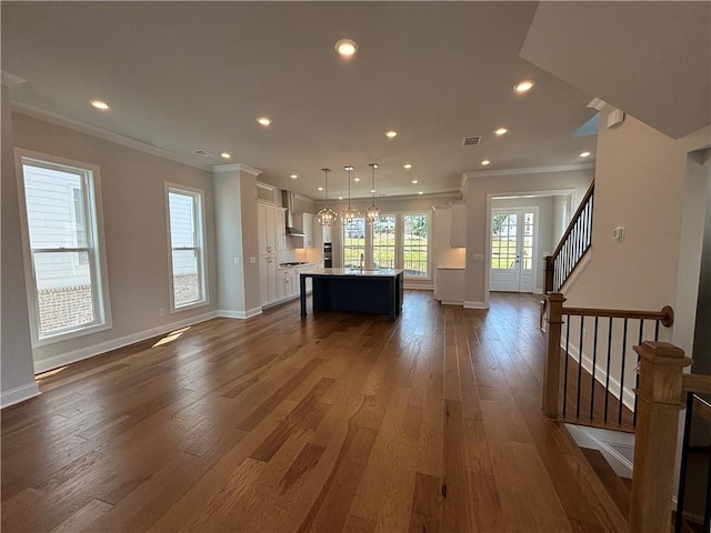 173 Basil St, Cumming, GA 30040 - living room featuring ornamental molding, dark wood-style floors, baseboards, recessed lighting, and stairs
