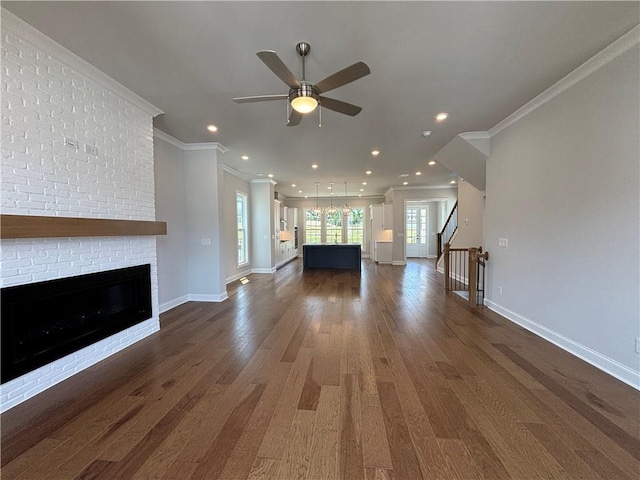 173 Basil St, Cumming, GA 30040 - unfurnished living room featuring dark wood-style floors, ornamental molding, ceiling fan, a brick fireplace, and baseboards