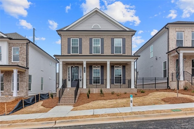 173 Basil St, Cumming, GA 30040 - view of front of property featuring covered porch and brick siding
