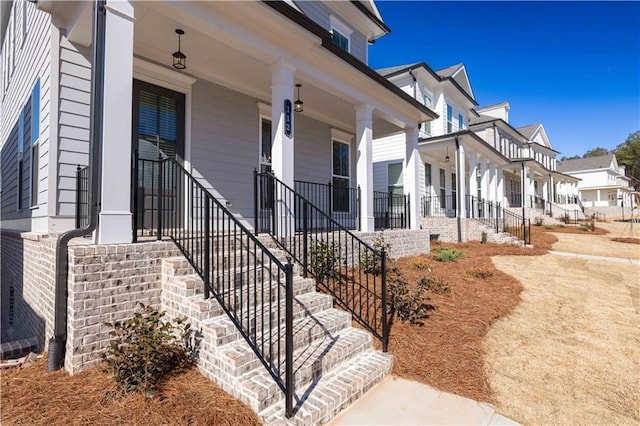 173 Basil St, Cumming, GA 30040 - view of exterior entry with a porch and a residential view