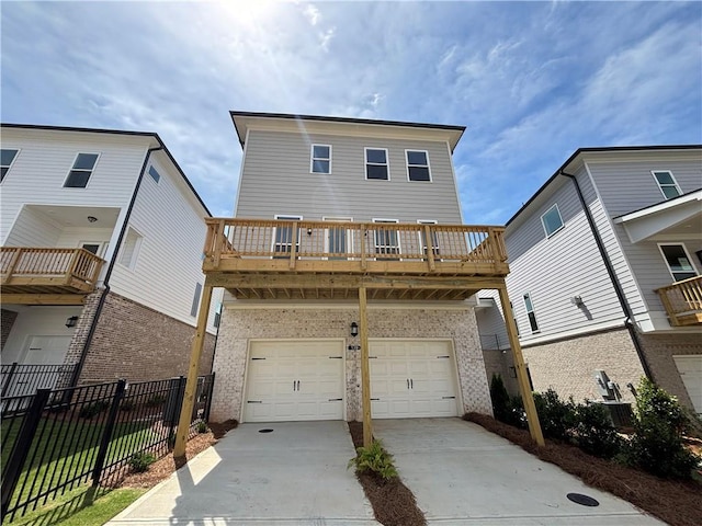 173 Basil St, Cumming, GA 30040 - view of front facade featuring brick siding, concrete driveway, an attached garage, and a wooden deck