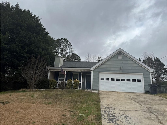 ranch-style home featuring an attached garage, a porch, a front yard, a chimney, and driveway