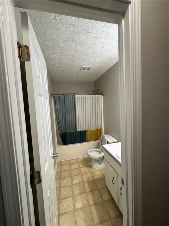 bathroom with visible vents, toilet, tile patterned floors, vanity, and shower / bathtub combination with curtain