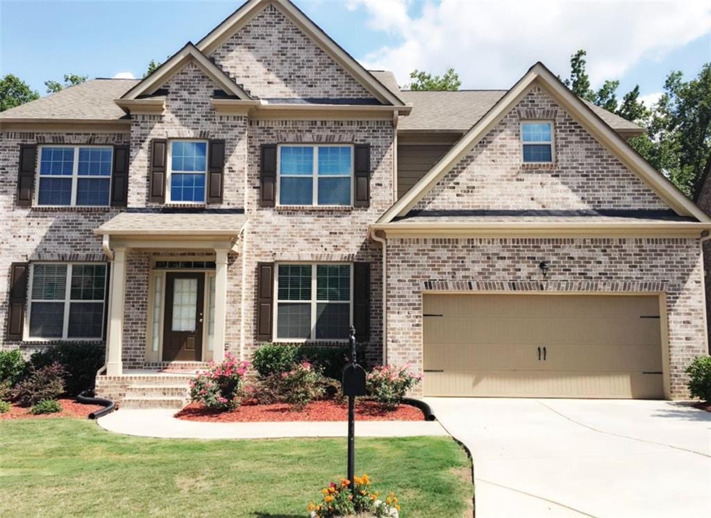 craftsman inspired home featuring a garage and a front yard