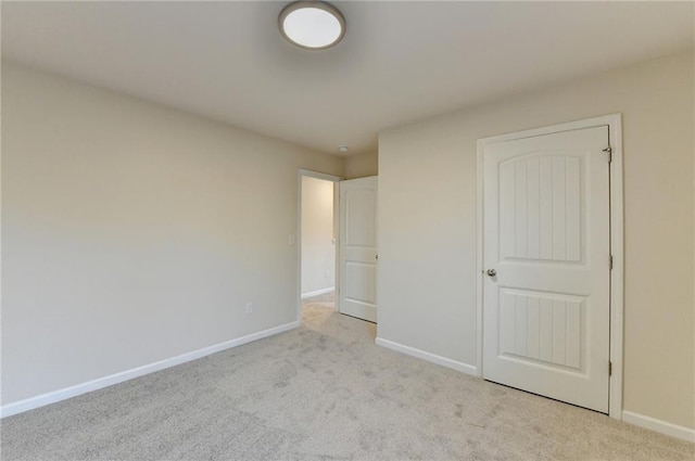 unfurnished bedroom with carpet and baseboards