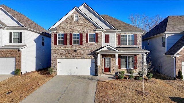 craftsman-style house featuring an attached garage, concrete driveway, and brick siding