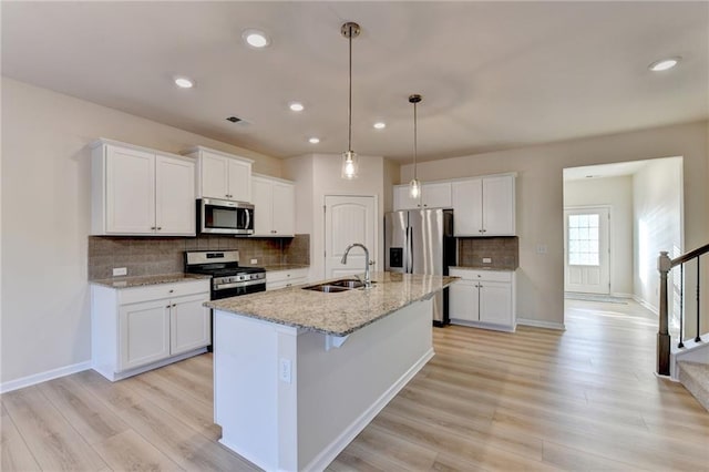 kitchen with white cabinets, stainless steel appliances, and a sink