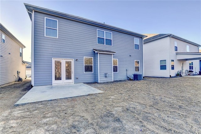 rear view of house featuring a patio area and central AC