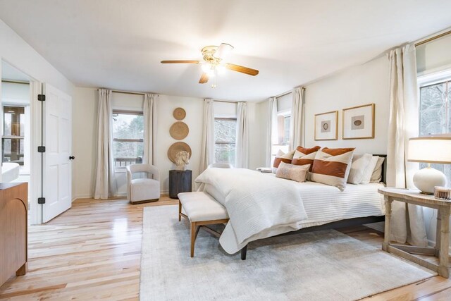 bedroom with light hardwood / wood-style flooring and ceiling fan