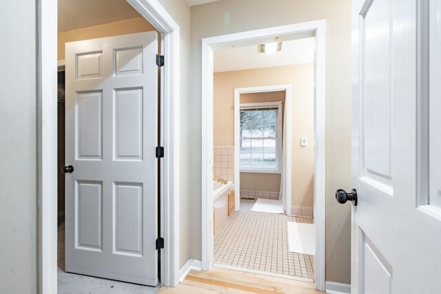 hall with light tile patterned floors