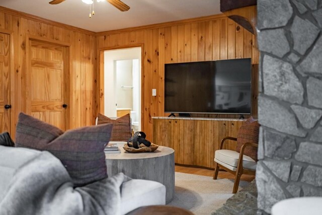 living room with ceiling fan and crown molding