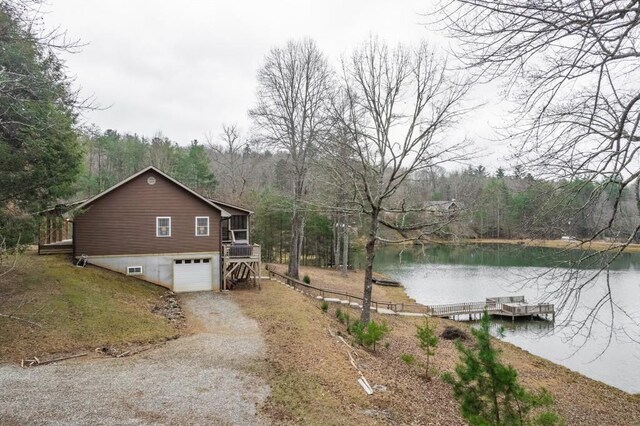 view of side of home with a garage and a water view