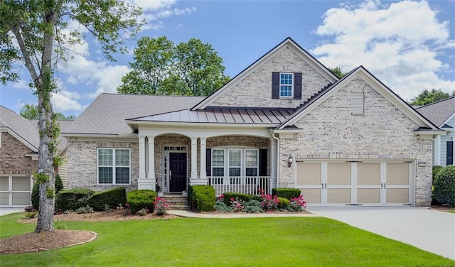 6416 Hickory Springs Cir, Hoschton, GA 30548 - view of front of property with concrete driveway, a front lawn, a porch, brick siding, and a standing seam roof