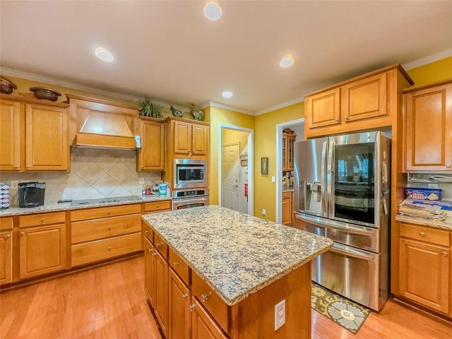 6416 Hickory Springs Cir, Hoschton, GA 30548 - kitchen featuring appliances with stainless steel finishes, custom range hood, ornamental molding, light wood-type flooring, and a center island