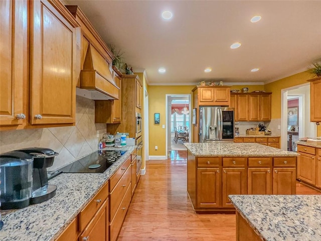 6416 Hickory Springs Cir, Hoschton, GA 30548 - kitchen with stainless steel appliances, ornamental molding, baseboards, light stone counters, and brown cabinetry