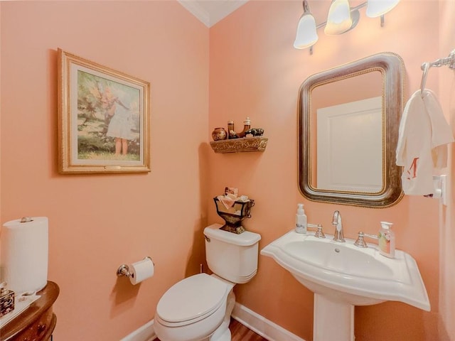 6416 Hickory Springs Cir, Hoschton, GA 30548 - half bath featuring toilet, baseboards, crown molding, and a sink