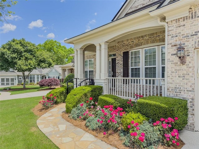 6416 Hickory Springs Cir, Hoschton, GA 30548 - doorway to property featuring a porch, a yard, and brick siding