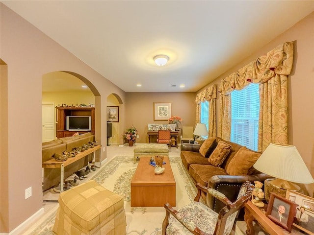 6416 Hickory Springs Cir, Hoschton, GA 30548 - carpeted living room with arched walkways, recessed lighting, and baseboards