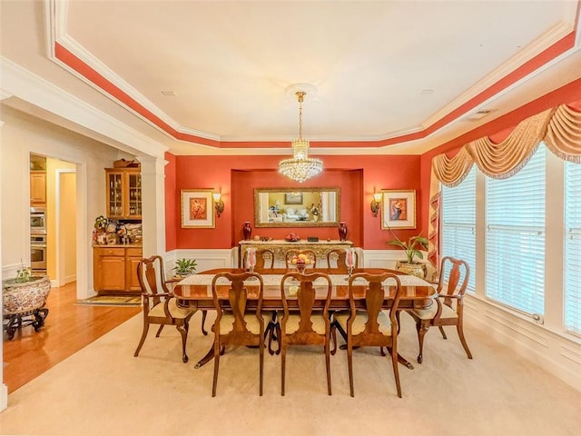6416 Hickory Springs Cir, Hoschton, GA 30548 - dining space with a chandelier, crown molding, wainscoting, a tray ceiling, and light wood finished floors