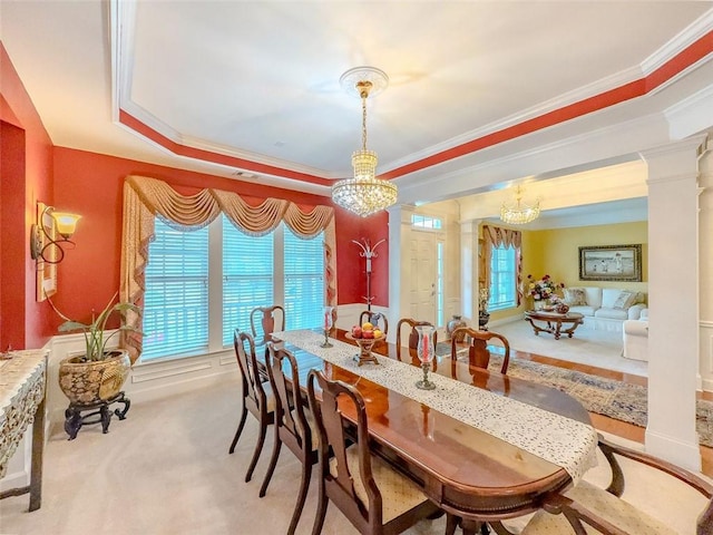 6416 Hickory Springs Cir, Hoschton, GA 30548 - carpeted dining space featuring a chandelier, crown molding, ornate columns, and a raised ceiling