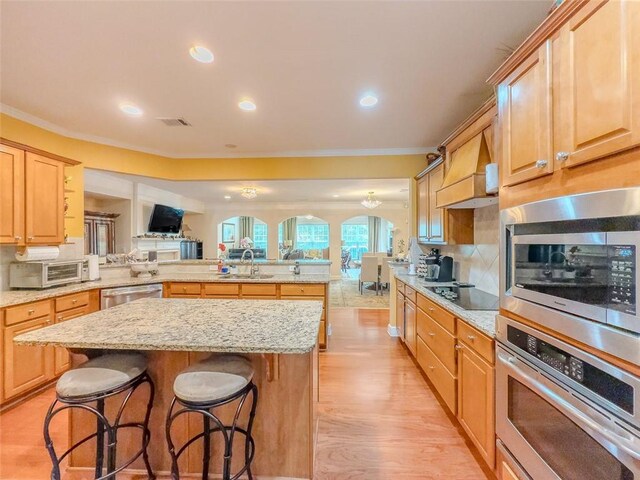 6416 Hickory Springs Cir, Hoschton, GA 30548 - kitchen featuring appliances with stainless steel finishes, a peninsula, a sink, custom exhaust hood, and open floor plan