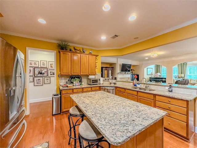 6416 Hickory Springs Cir, Hoschton, GA 30548 - kitchen featuring stainless steel appliances, a sink, open floor plan, a peninsula, and arched walkways