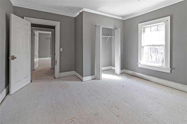 unfurnished bedroom with a closet and crown molding