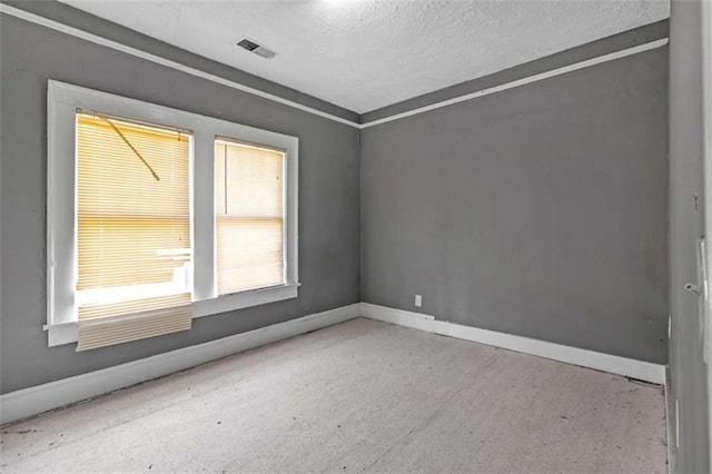 empty room featuring a textured ceiling