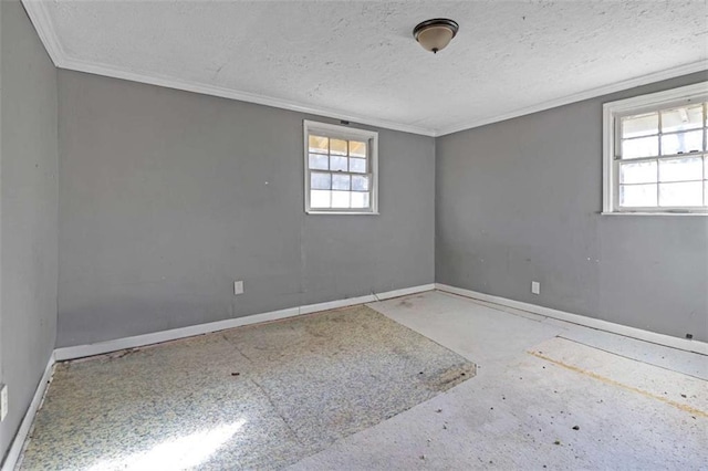 spare room featuring ornamental molding and a textured ceiling