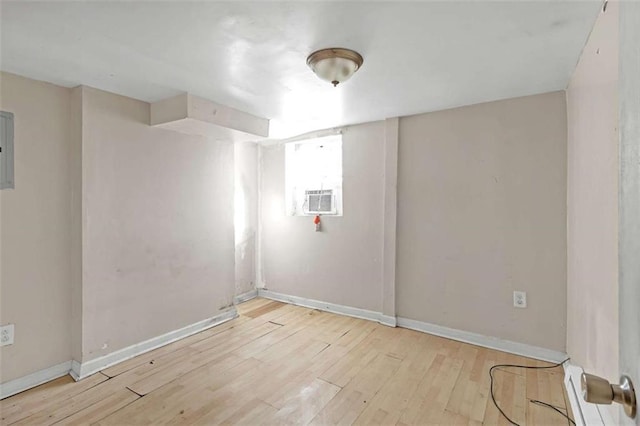 unfurnished room featuring light wood-type flooring and cooling unit