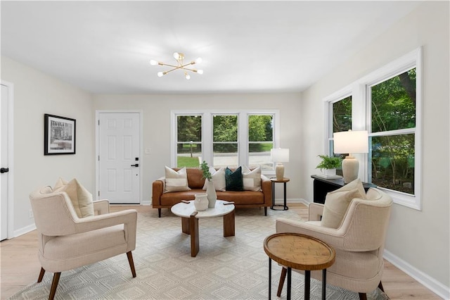 living room featuring light hardwood / wood-style floors and an inviting chandelier