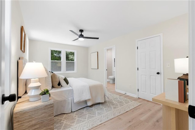 bedroom with ceiling fan, light hardwood / wood-style floors, and ensuite bath