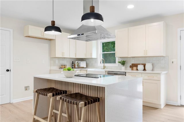 kitchen featuring a center island, black electric cooktop, white cabinetry, and hanging light fixtures