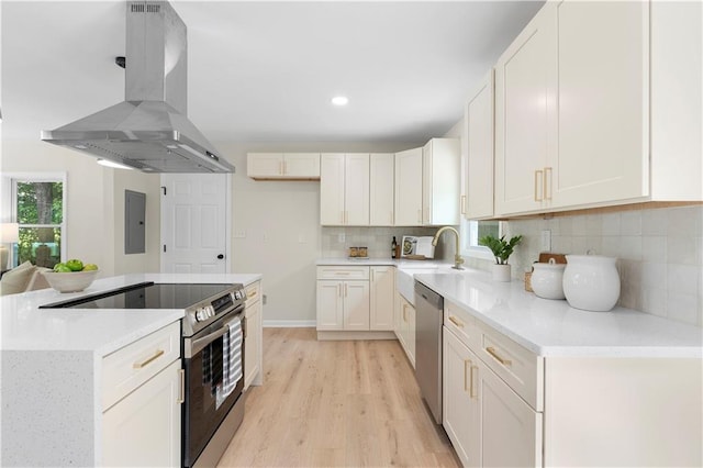 kitchen with ventilation hood, sink, white cabinets, and stainless steel appliances