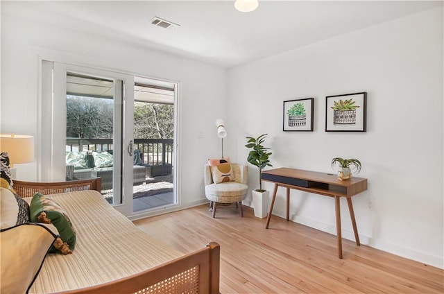 bedroom with access to outside and light hardwood / wood-style floors