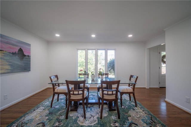 dining space with crown molding and dark hardwood / wood-style floors