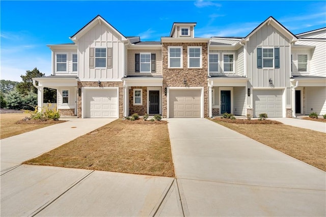 323 Rolling Green Rd, Adairsville, GA 30103 - townhome / multi-family property with board and batten siding, stone siding, concrete driveway, and a garage