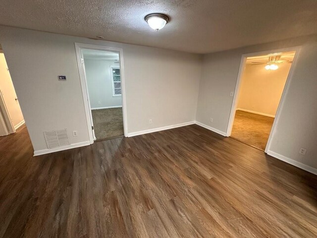 1095 S Burnt Hickory Rd, Douglasville, GA 30134 - unfurnished room with a textured ceiling, baseboards, and dark wood-style floors