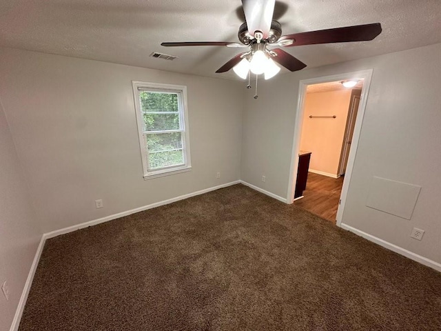 1095 S Burnt Hickory Rd, Douglasville, GA 30134 - unfurnished room featuring ceiling fan, baseboards, dark colored carpet, and a textured ceiling