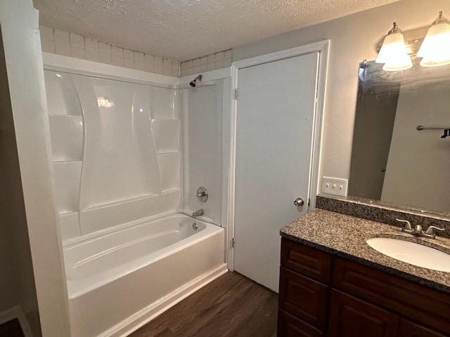 1095 S Burnt Hickory Rd, Douglasville, GA 30134 - full bath with wood finished floors, a textured ceiling, tub / shower combination, and vanity